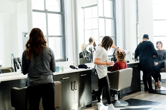 A hair salon with full of customers.